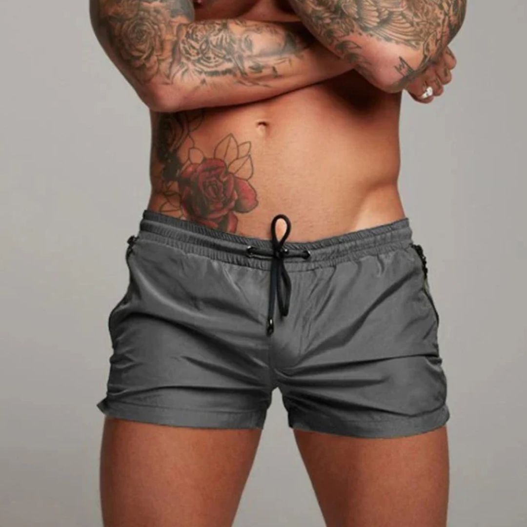 Men's swim shorts with zip pockets and drawstring waist, available in multiple colours