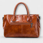 Women structured handbag in a balanced silhouette available in Black Blue Red and Brown