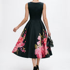 Black midi cocktail dress with floral print A-line skirt and sleeveless bateau neckline