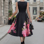 Black midi cocktail dress with floral print A-line skirt and sleeveless bateau neckline