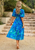 Floral midi dress with puff sleeves and flattering waist-tailored fit
