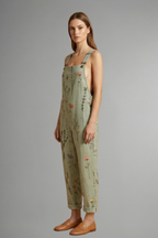 Women's wide leg jumpsuit in green with square neckline and adjustable straps