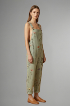 Women's wide leg jumpsuit in green with square neckline and adjustable straps