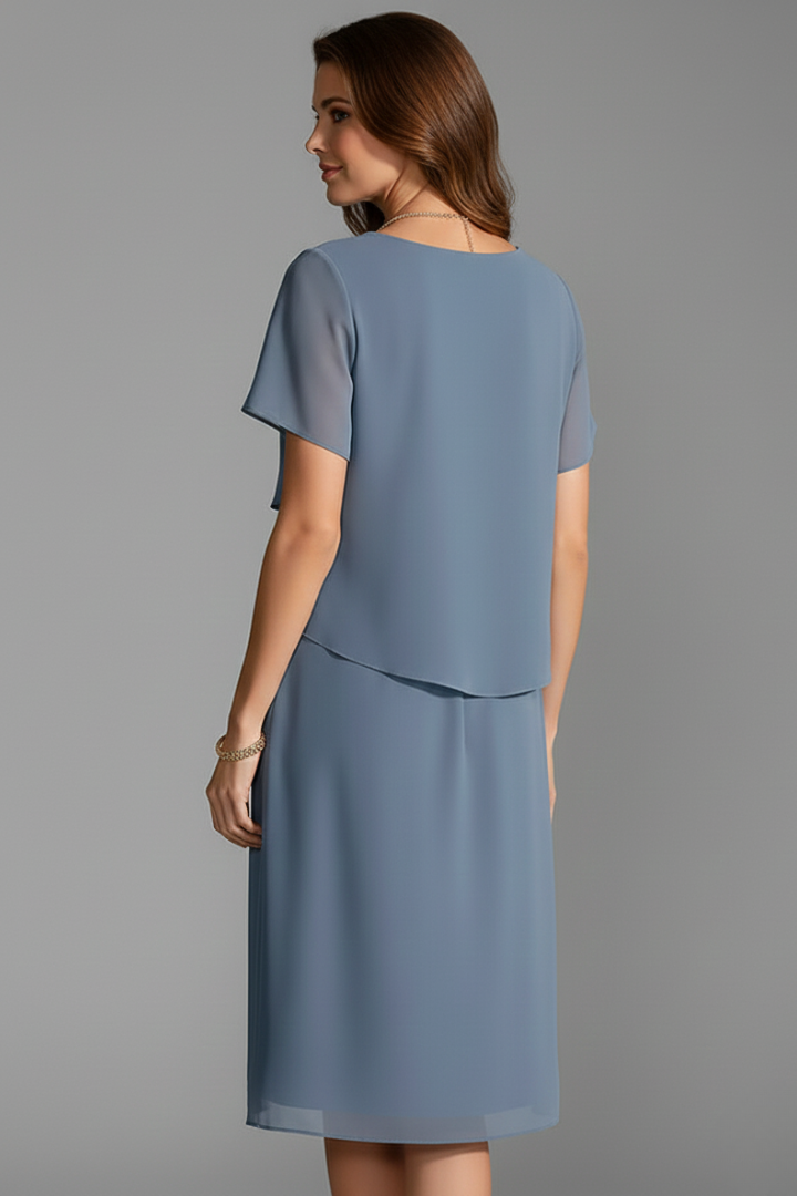 Women's short sleeve dress with layered front panel and straight knee-length hem