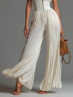 Women's white wide-leg jumpsuit with deep V-neck and sleeveless cut