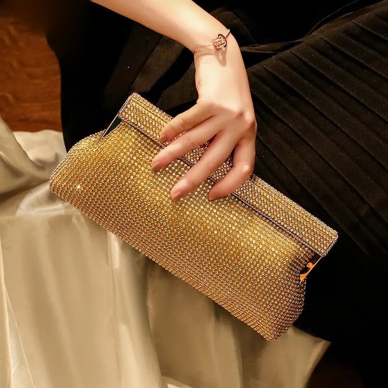 Gold evening clutch bag with crystal embellishments and snap closure