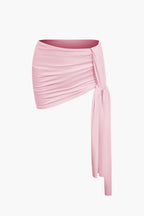 Women's two-piece set with one-shoulder top and draped mini skirt, asymmetric knot detail