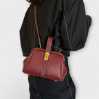 Women mini crossbody bag with twist lock closure in faux leather