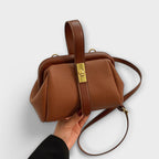 Women mini crossbody bag with twist lock closure in faux leather