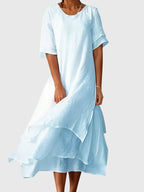 Women's elegant dress with open neckline and fluid cut, available in multiple colours