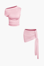 Women's two-piece set with one-shoulder top and draped mini skirt, asymmetric knot detail