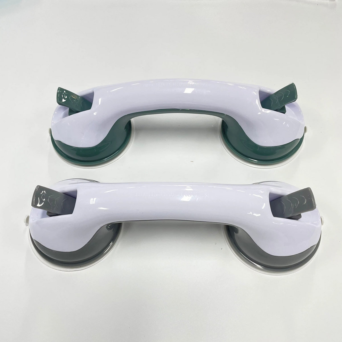 Bathroom safety grab bar with suction cups mounted on tile wall for senior support