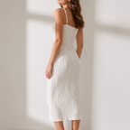 Sleeveless fitted midi dress with subtle ripple texture, available in white and black